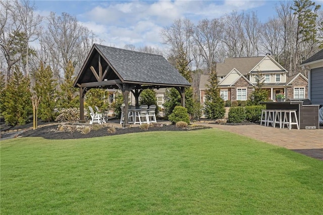 view of yard with outdoor dry bar and a gazebo