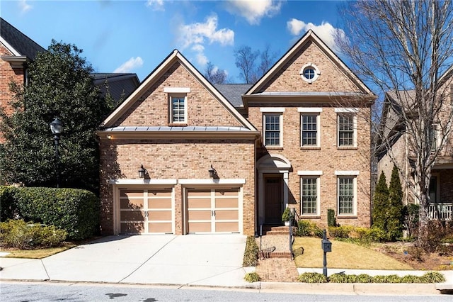 view of front facade featuring a garage, concrete driveway, brick siding, and a standing seam roof