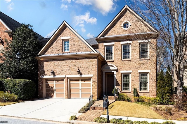 view of front facade featuring driveway, a garage, metal roof, a standing seam roof, and brick siding