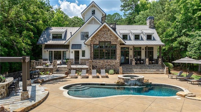151 Blue Heron Dr, Eatonton, GA 31024 - back of property featuring a patio area, board and batten siding, a standing seam roof, metal roof, and a pool with connected hot tub