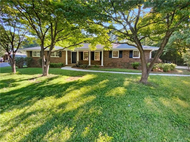 ranch-style home featuring a front yard