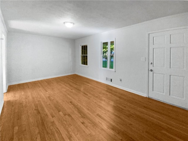 unfurnished room with hardwood / wood-style flooring