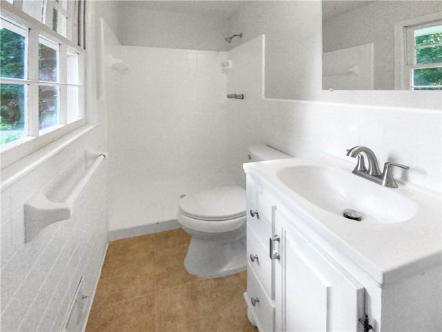 bathroom with walk in shower, tasteful backsplash, tile patterned floors, toilet, and vanity