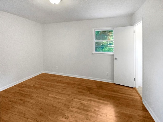 empty room with hardwood / wood-style floors