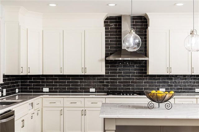 kitchen with stainless steel dishwasher, decorative backsplash, wall chimney range hood, and white cabinetry