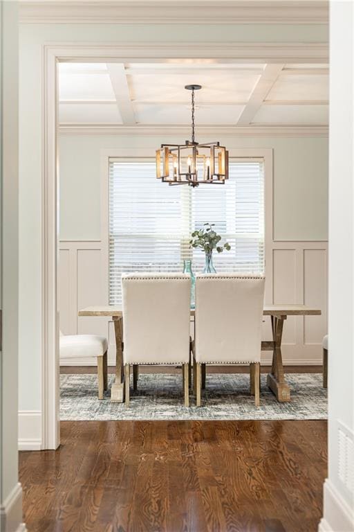 dining room featuring a wealth of natural light, dark hardwood / wood-style flooring, beamed ceiling, and an inviting chandelier