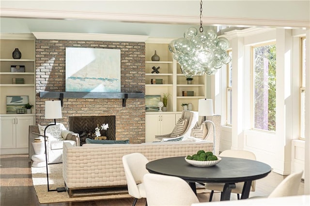 interior space featuring a fireplace, ornamental molding, built in features, and hardwood / wood-style flooring