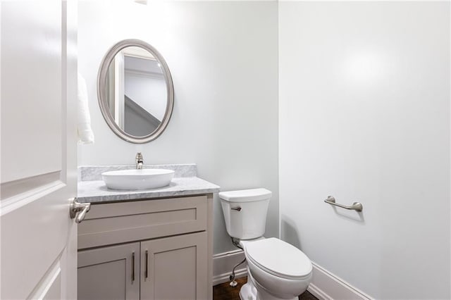 bathroom featuring toilet and vanity