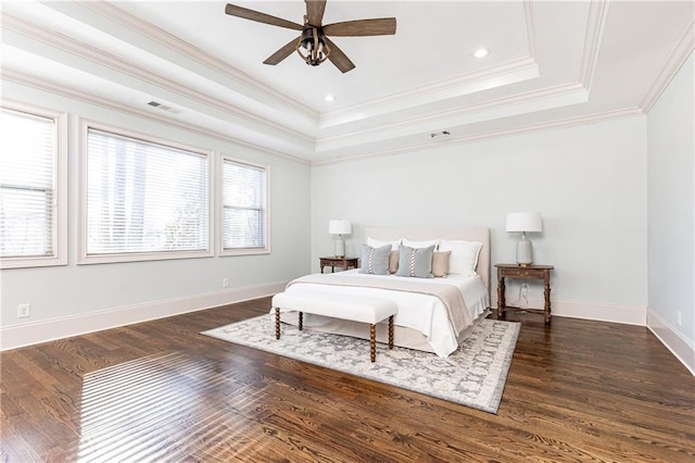 bedroom with ceiling fan, ornamental molding, and a tray ceiling