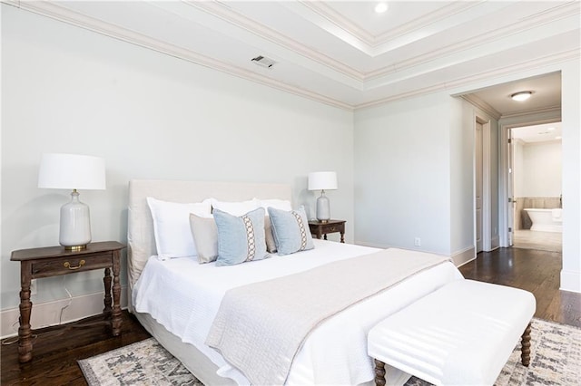 bedroom featuring ensuite bathroom, ornamental molding, and dark hardwood / wood-style floors