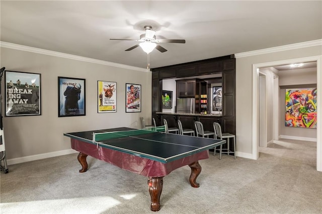 rec room with ceiling fan, light carpet, and ornamental molding