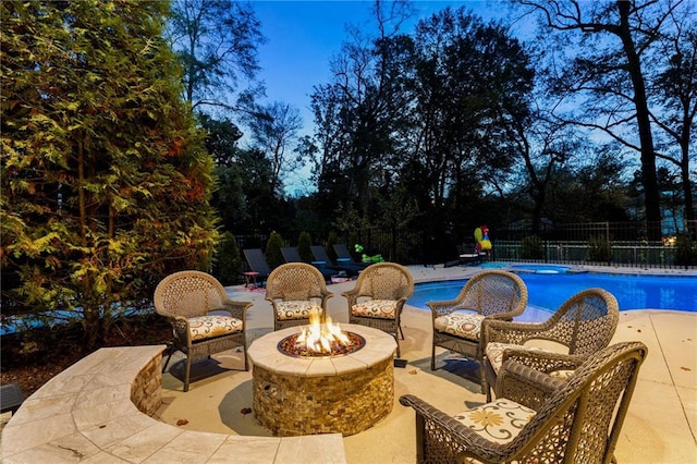 view of swimming pool with a patio and a fire pit