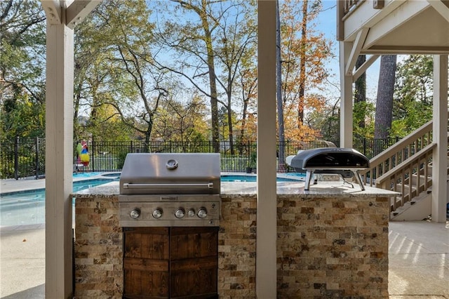 view of patio featuring a fenced in pool, grilling area, and area for grilling