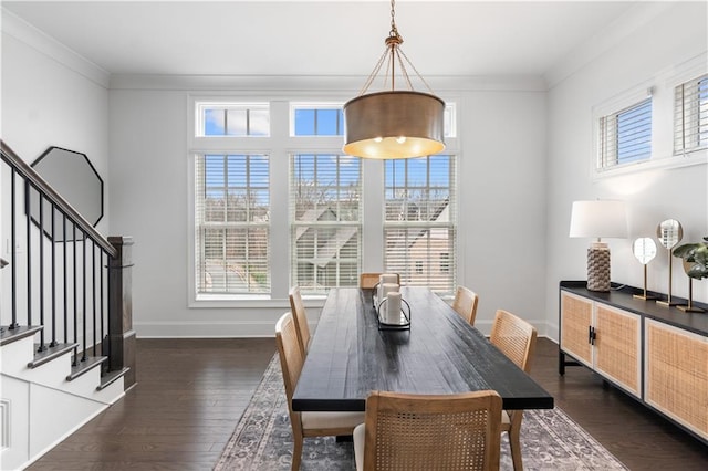 dining room featuring dark wood-type flooring and ornamental molding