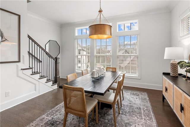 dining space with a healthy amount of sunlight, ornamental molding, and dark hardwood / wood-style floors