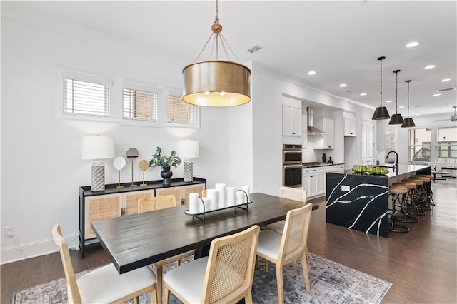 dining space with ceiling fan and dark hardwood / wood-style flooring