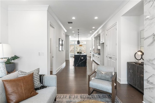 living room with crown molding and dark hardwood / wood-style flooring