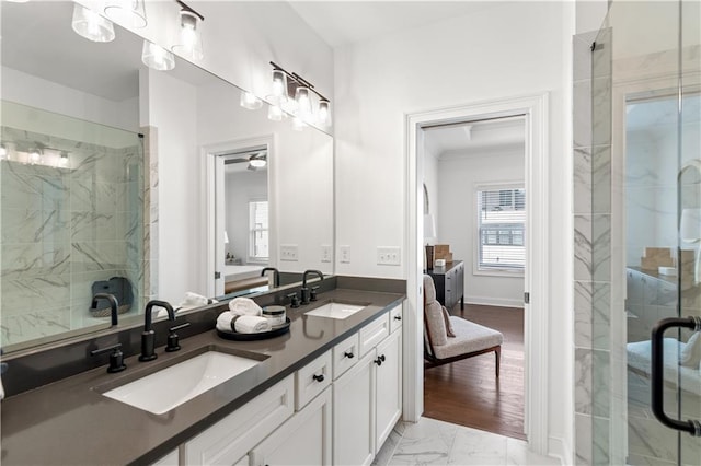 bathroom featuring vanity, wood-type flooring, and a shower with shower door