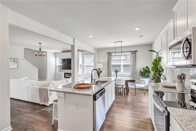 36 Mead Ct, Hoschton, GA 30548 - kitchen featuring appliances with stainless steel finishes, white cabinets, dark wood-style flooring, and recessed lighting