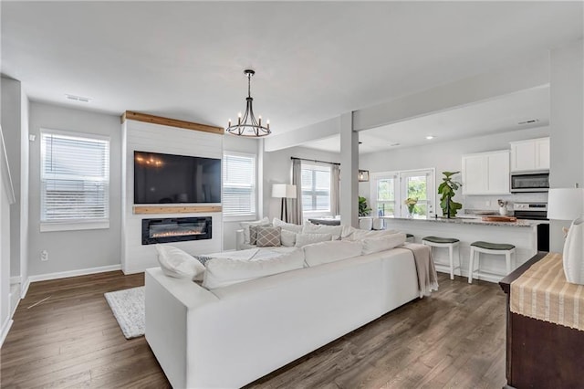 36 Mead Ct, Hoschton, GA 30548 - living room featuring dark wood-style floors, a fireplace, a chandelier, and recessed lighting