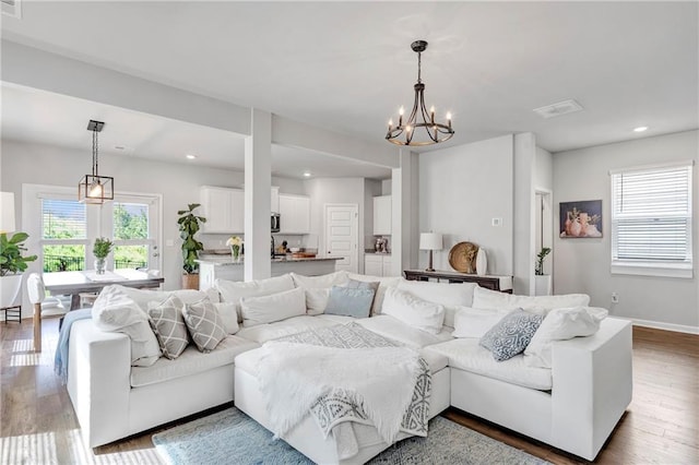 36 Mead Ct, Hoschton, GA 30548 - living area featuring healthy amount of natural light, wood finished floors, a chandelier, and recessed lighting