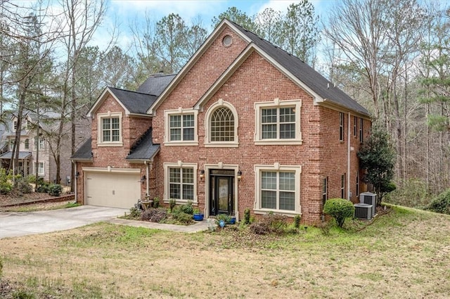 view of front facade with brick siding, a front yard, and concrete driveway