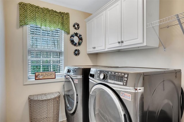 laundry room with cabinet space and separate washer and dryer