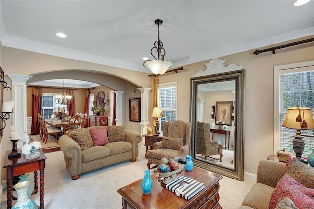 carpeted living room with ornamental molding, ornate columns, arched walkways, and recessed lighting