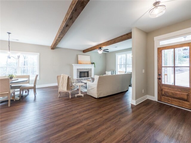 kitchen with sink, stainless steel fridge, white cabinets, a center island, and dark wood-type flooring