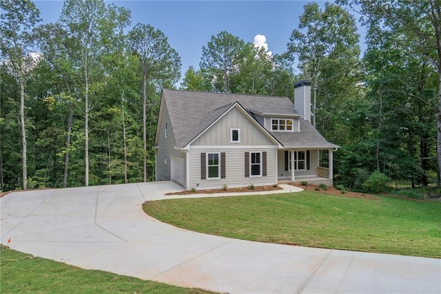 view of front of property with a porch, a garage, and a front yard