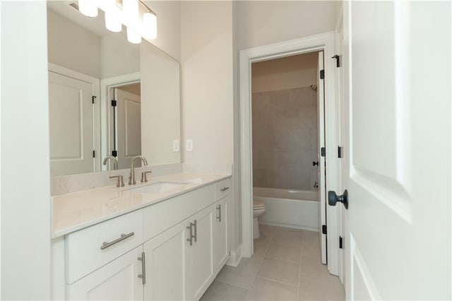 full bathroom with toilet, tile patterned floors, tiled shower / bath combo, and vanity