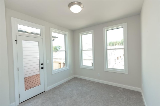 doorway to outside featuring light carpet