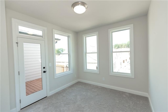 doorway featuring plenty of natural light and light colored carpet