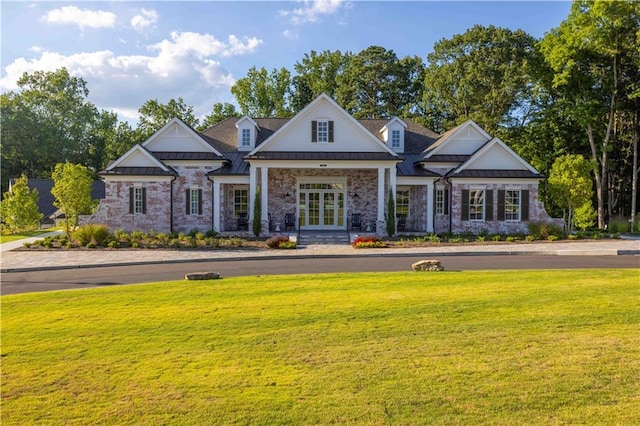 view of front of home with french doors and a front lawn