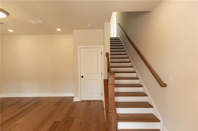 stairs with hardwood / wood-style flooring