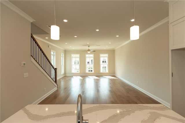 unfurnished living room featuring crown molding, hardwood / wood-style floors, and ceiling fan