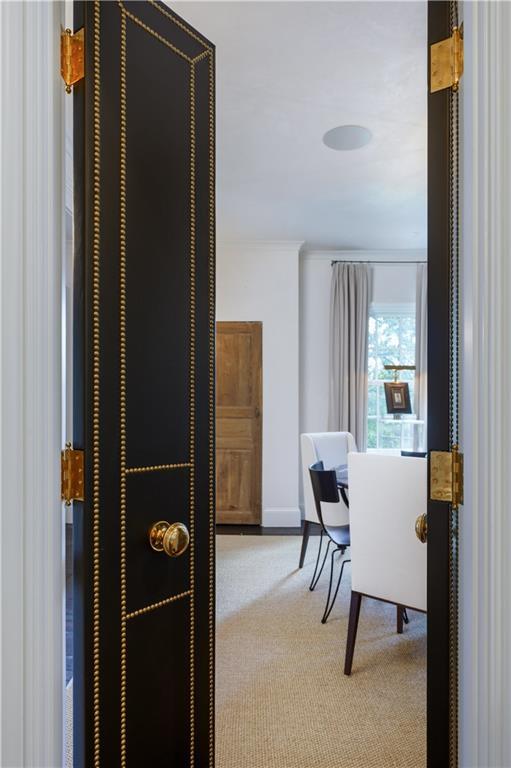 office space with baseboards, carpet floors, and crown molding