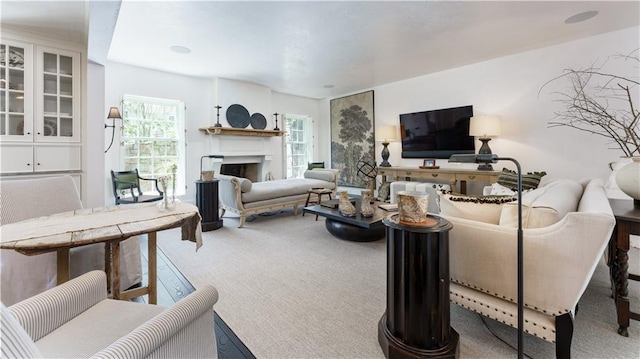 living room featuring a fireplace and carpet