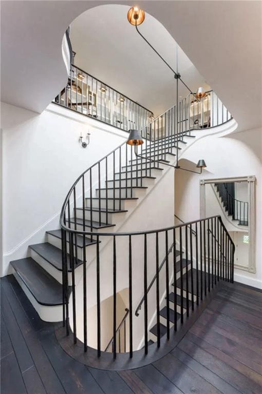 stairway with baseboards and hardwood / wood-style flooring