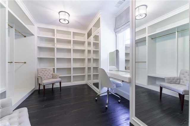 office area featuring built in shelves, dark wood-style floors, and crown molding