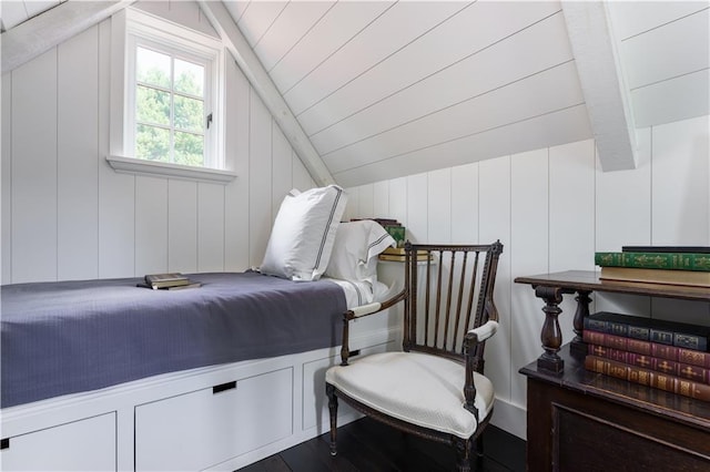 bedroom with wooden ceiling, vaulted ceiling with beams, and wood finished floors