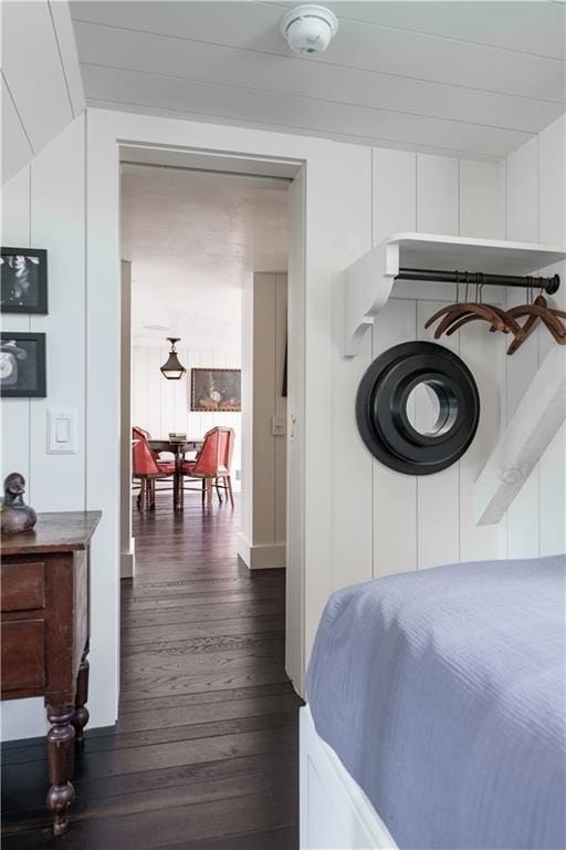 bedroom featuring lofted ceiling and dark wood finished floors