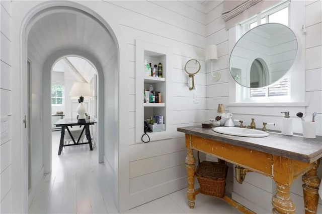 bathroom featuring wood finished floors and a sink