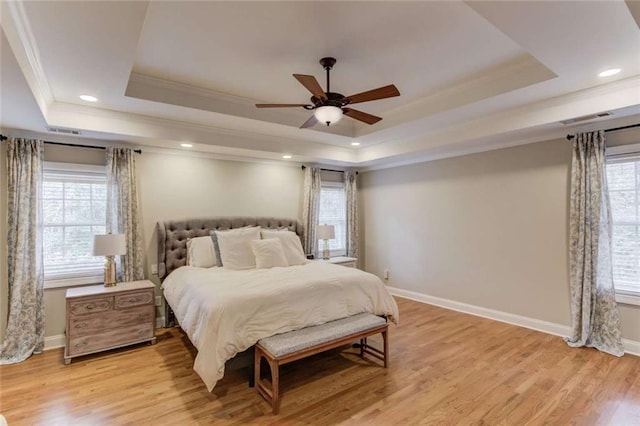 3000 The Springs Dr, Monroe, GA 30656 - bedroom featuring a tray ceiling, crown molding, multiple windows, light wood-style floors, and recessed lighting