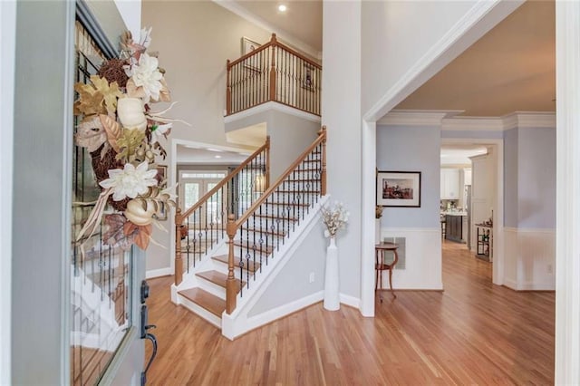 3000 The Springs Dr, Monroe, GA 30656 - entrance foyer with wood finished floors, stairway, wainscoting, crown molding, and a high ceiling