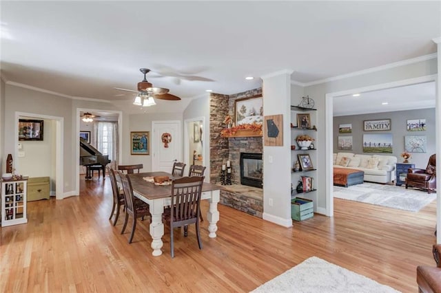 3000 The Springs Dr, Monroe, GA 30656 - dining area with a stone fireplace, light wood finished floors, a ceiling fan, ornamental molding, and recessed lighting