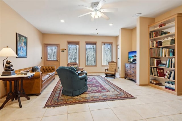 sitting room featuring ceiling fan and light tile patterned flooring