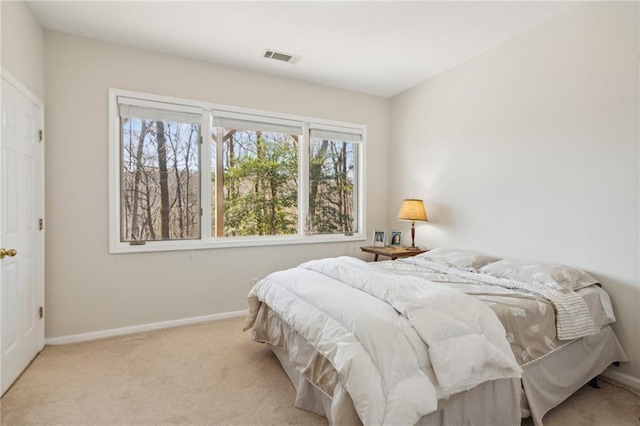 bedroom featuring light colored carpet