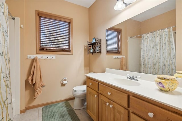 bathroom with tile patterned flooring, vanity, toilet, and a wealth of natural light