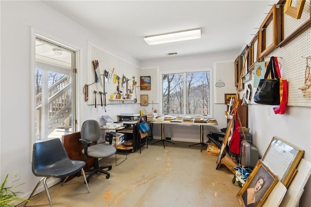 misc room with a workshop area and concrete floors